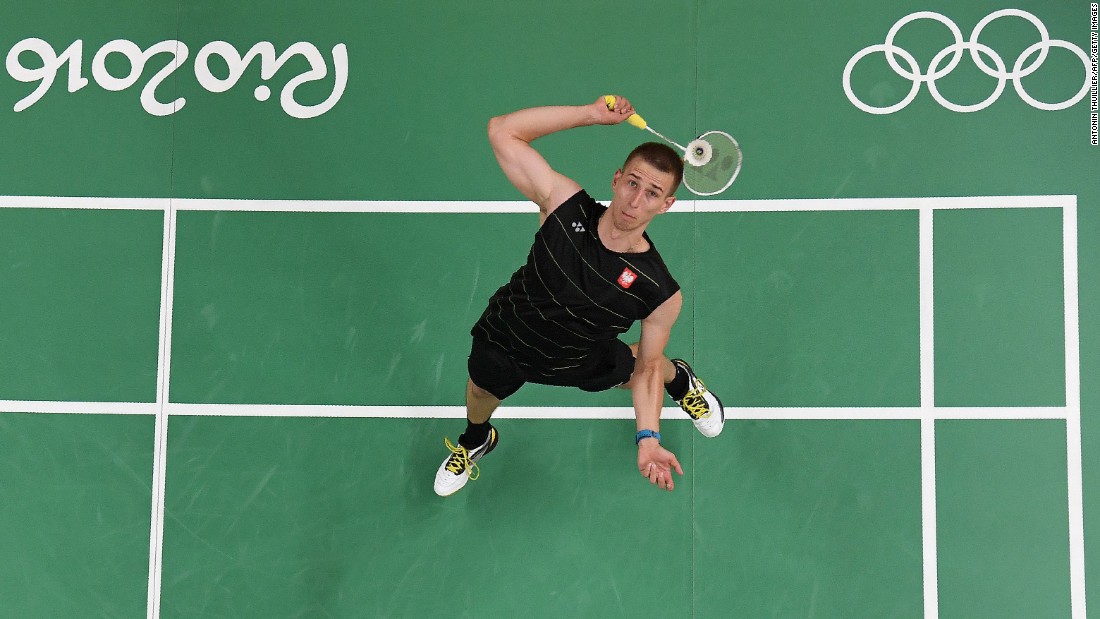 Poland&#39;s Adrian Dziolko serves to China&#39;s Chen Long during their singles qualifying badminton match.