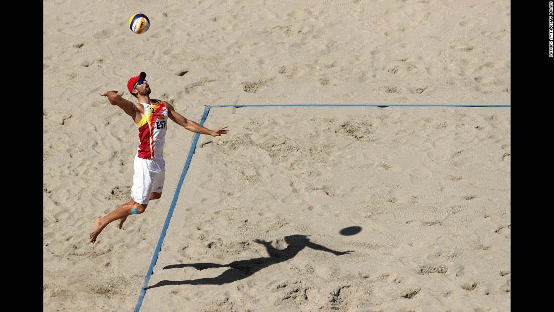 Adrian Gavira Collado of Spain serves the ball during a round of 16 beach volleyball match.