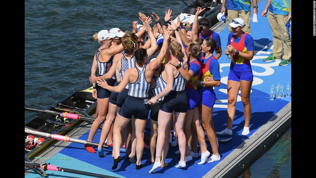 Team USA celebrates winning the gold with members of Romania&#39;s team, who won the bronze, in the women&#39;s eight rowing competition.