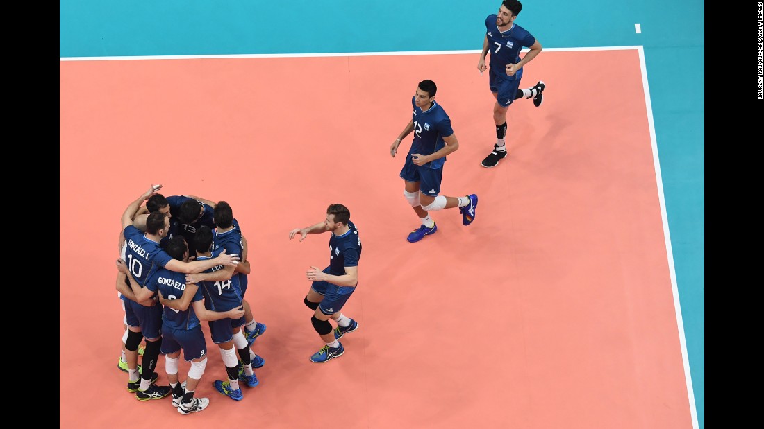 Argentina&#39;s players celebrate after winning their qualifying volleyball match against Cuba.