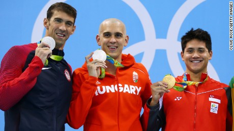Joint silver medalists, Michael Phelps of United States and Laszlo Cseh of Hungary and gold medalist Joseph Schooling of Singapore celebrate on the podium during the medals ceremony in the Men&#39;s 100m butterfly final.