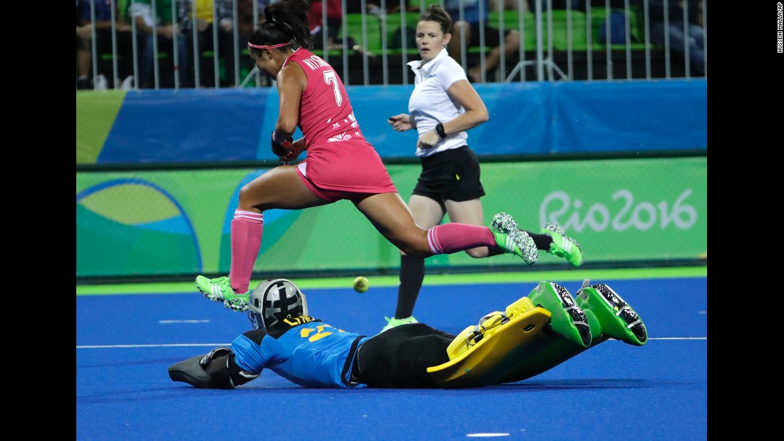 Field hockey player Aki Mitsuhashi of Japan, top, fights for the ball with Australia&#39;s goalkeeper Rachael Lynch during their preliminary match.