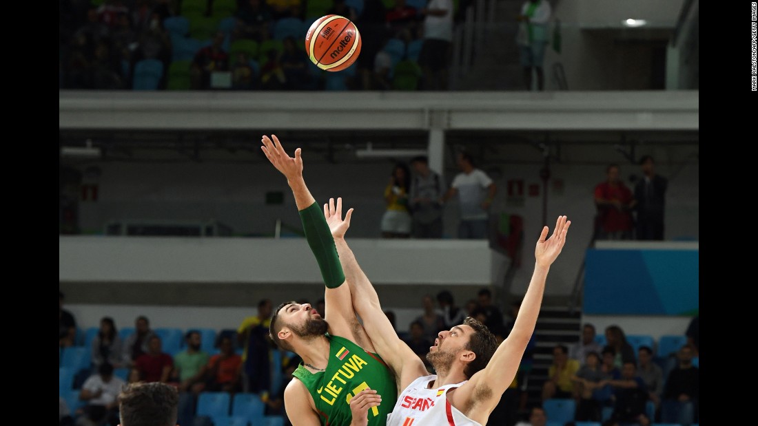 Jonas Valanciunas of Lithuania, left, and Spain&#39;s Pau Gasol face off in a preliminary basketball match. Spain won 109-59.
