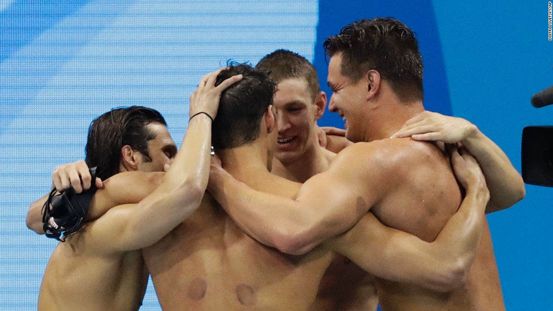 Swimmers Michael Phelps, Cody Miller, Ryan Murphy and Nathan Adrian of the United States embrace after winning the 4x100-meters medley. Murphy led the team early on with his world record backstroke leg, and the team ended up solidifying gold with an Olympic record finish.