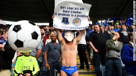 An Everton supporter holds a sign in May urging BBC presenter Gary Lineker to keep his promise.
