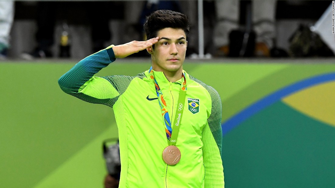 Bronze medalist Arthur Mariano of Brazil salutes during the medal ceremony for Men&#39;s Gymnastics Floor Exercise.