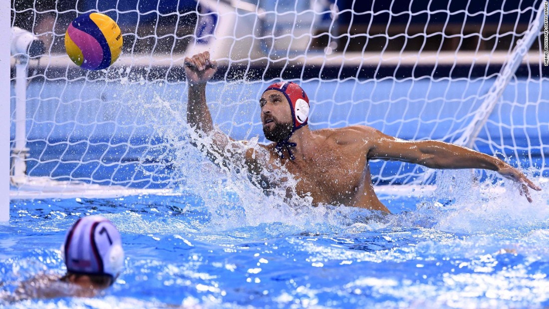US goalie Merrill Moses saves a shot against Italy during in a men&#39;s water polo preliminary round match. The Americans won 10-7.