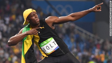 Bolt does his &quot;Lightening Bolt&#39; pose as he celebrates winning the 100 meters.