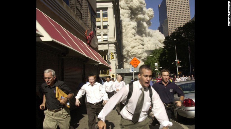 People run as the building collapses.