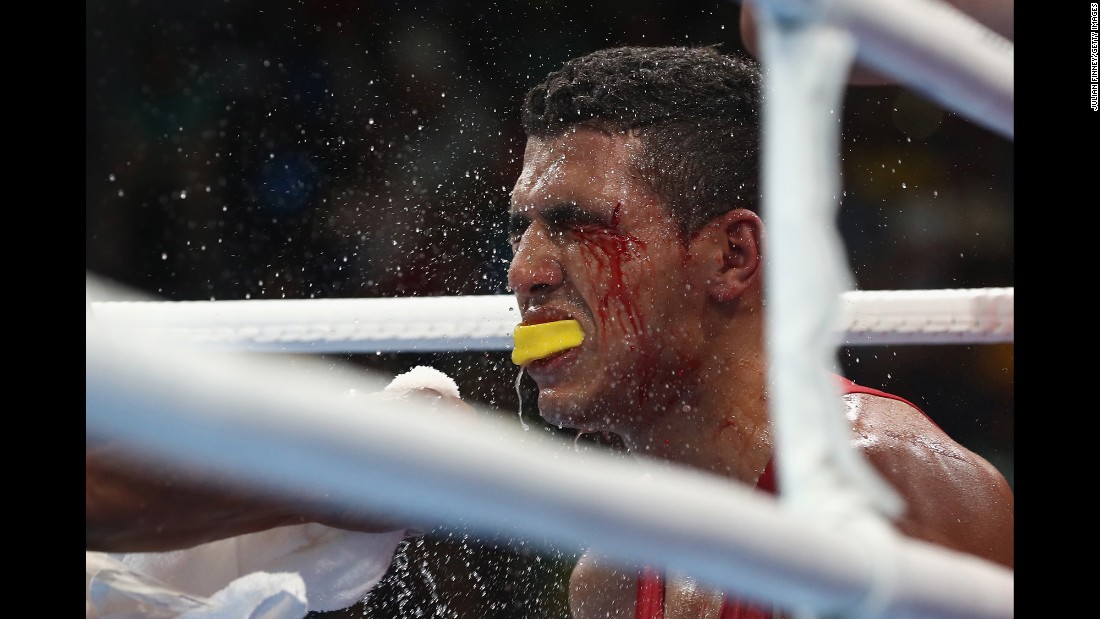 The trainer of Moroccan boxer Mohammed Rabil sprays water onto Rabil&#39;s face during his welterweight bout against Uzbekistan&#39;s Shakhram Giyasov. Giyasov won to advance to the final.