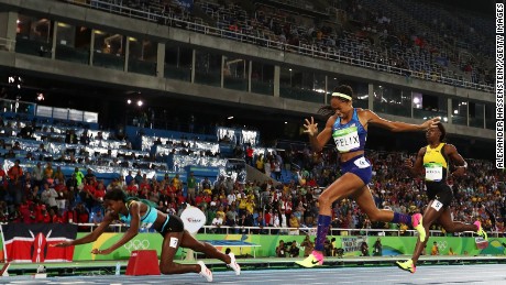Shaunae Miller dives over the finish line to win the gold medal in the women&#39;s 400-meter final ahead of  Allyson Felix of the United States.