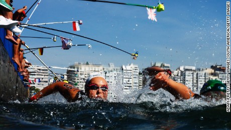 Aurelie Muller of France takes on refreshments during the Women&#39;s 10km Marathon Swim.