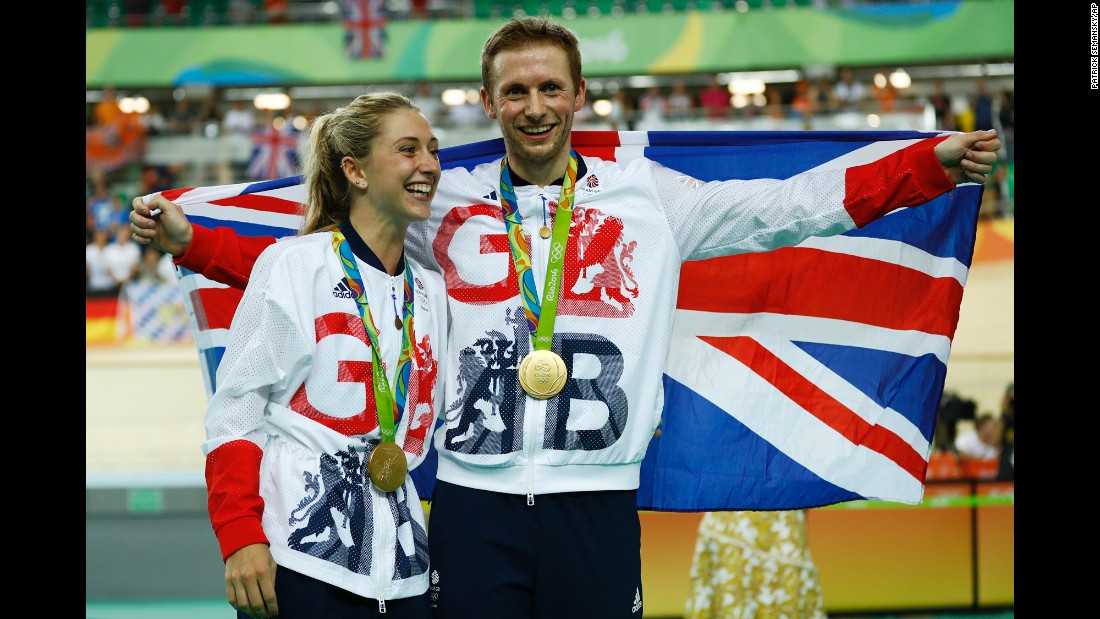 Great Britain&#39;s Laura Trott and her fiance, Jason Kenny, pose with their gold medals in track cycling. Kenny won the keirin and Trott won the omnium.