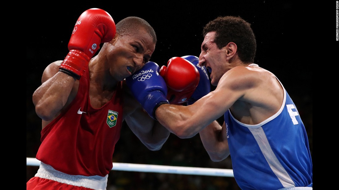 Brazil&#39;s Robson Conceicao, left, boxes France&#39;s Sofiane Oumiha in the lightweight final. Conceicao won the bout to earn the host country its first-ever gold medal in boxing.