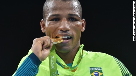 Brazil&#39;s Robson Conceicao poses with a gold medal at the Rio 2016 Olympic Games in Rio de Janeiro on August 16, 2016.  