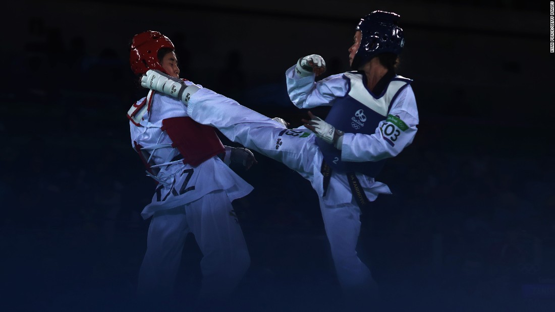 Ainur Yesbergenova of Kazakhstan, left, and Croatia&#39;s Lucija Zaninovic compete in a taekwondo bout.