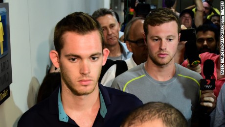 American swimmers Gunnar Bentz (L) and Jack Conger leave the police station at the Rio de Janeiro International Airport after being detained on the plane that would travel back to the US.  
Brazilian police arrested two US swimmers and a top International Olympic Committee official as scandal overshadowed the Rio Games and Usain Bolt&#39;s progress toward a new gold.  Jack Conger and Gunnar Bentz were taken off a flight leaving Rio de Janeiro by authorities investigating doubts over their claim to have been mugged. / AFP / TASSO MARCELO        (Photo credit should read TASSO MARCELO/AFP/Getty Images)