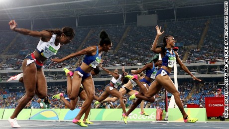 Brianna Rollins of the United States (R) wins the gold medal in the Women&#39;s 100m Hurdles Final in front of many empty seats.