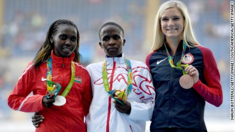 Ruth Jebet (center) of Bahrain poses with her  gold medal.