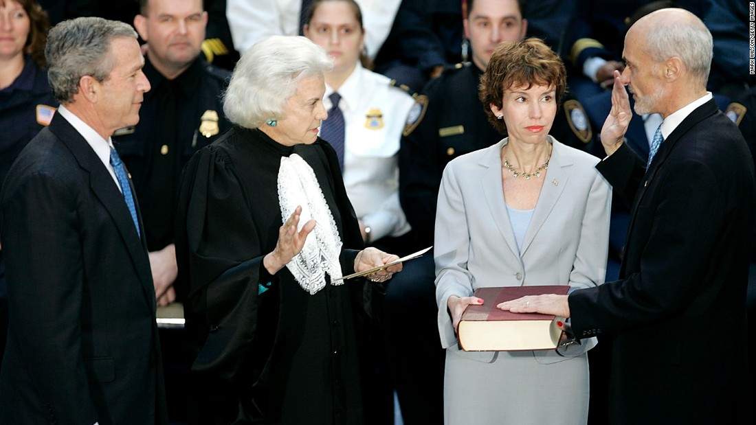 President George W. Bush, left, watches as Homeland Security Secretary Michael Chertoff, right, is sworn in by O&#39;Connor in March 2005. Chertoff&#39;s wife, Meryl, is holding the Bible.