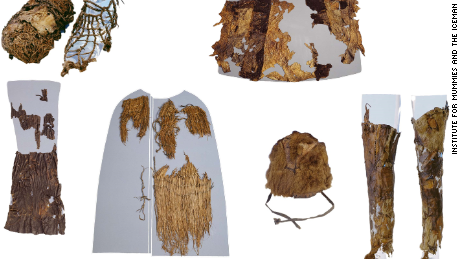 Otiz&#39;s clothing are on display from top left: A shoe with grass interior (left) and leather exterior (right), the leather coat (reassembled by the museum), leather loincloth, grass coat, fur hat, and leather leggings.