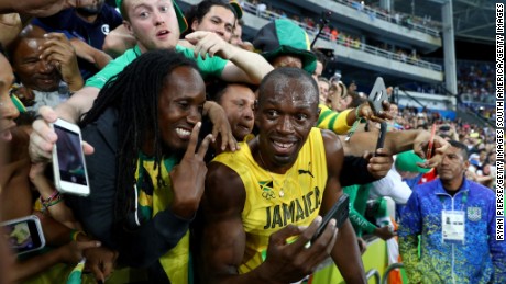 Fans&#39; favorite: Usain Bolt takes time to pose for selfies after winning the 200-meters in Rio