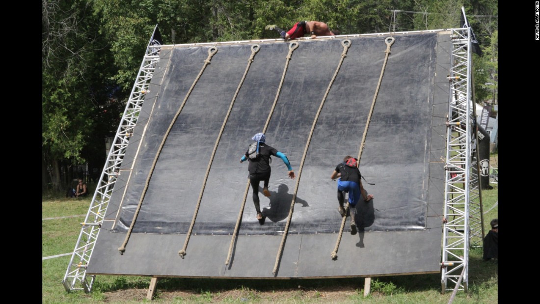 The final obstacle on the course is the Slip Wall. Some runners have enough speed to reach the top without using a rope.