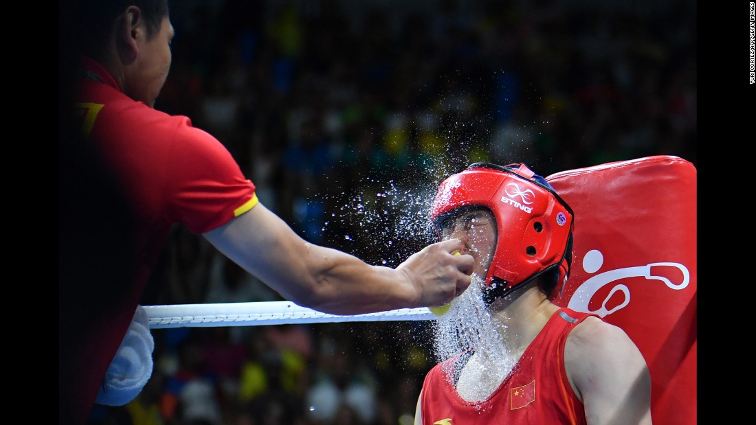 Water is splashed onto Chinese middleweight boxer Li Qian between rounds of her semifinal bout against the Netherlands&#39; Nouchka Fontijn.