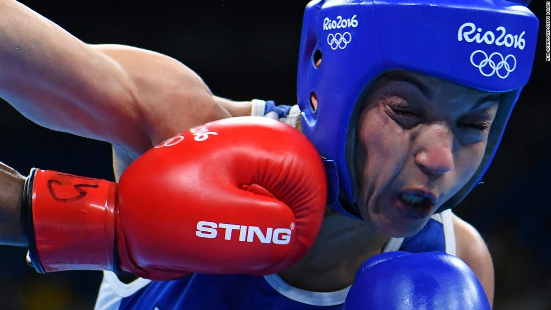British boxer Nicola Adams, left, punches Sarah Ourahmoune of France during their flyweight 51-kilogram (112-pound) final bout.