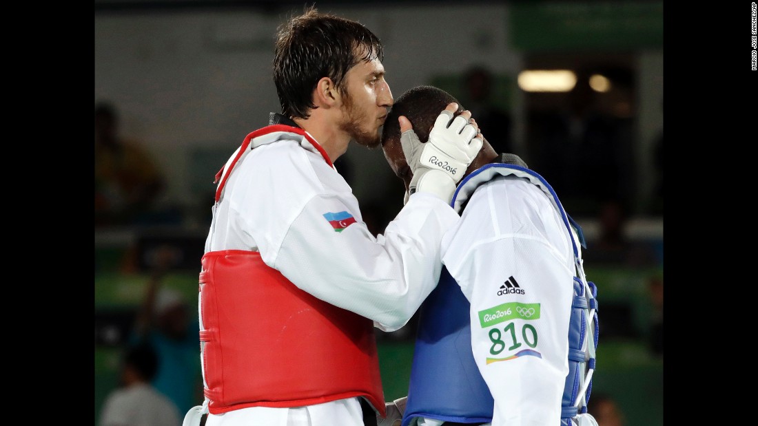Radik Isaev of Azerbaijan, left, kisses Great Britain&#39;s Mahama Cho after defeating Cho in the over 80-kilogram (176-pound) semifinal taekwondo event. 