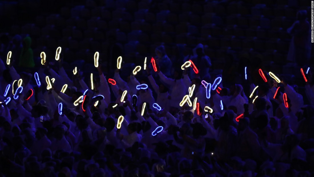 Members of Team Great Britain hold up their illuminated shoes.