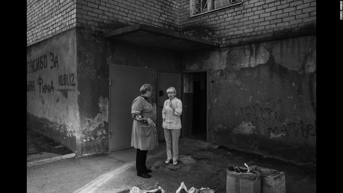 Two nurses take a break outside of a maternity ward in Kramatorsk, Ukraine. According to photographer Pascal Vossen and writer Nils Adler, the ward had no functioning toilets -- a sign of its poor condition.