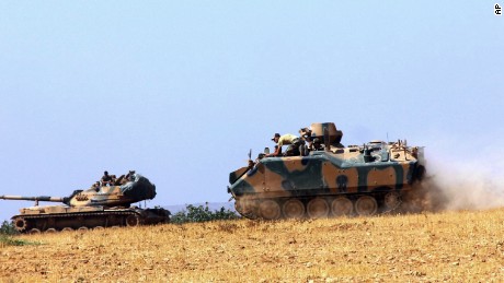 Turkish military vehicles move near the Syrian border in Karkamis on Tuesday.