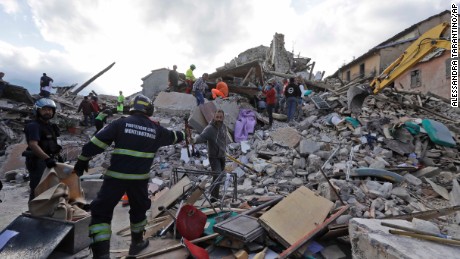 Rescuers search for survivors in the rubble in Amatrice. 