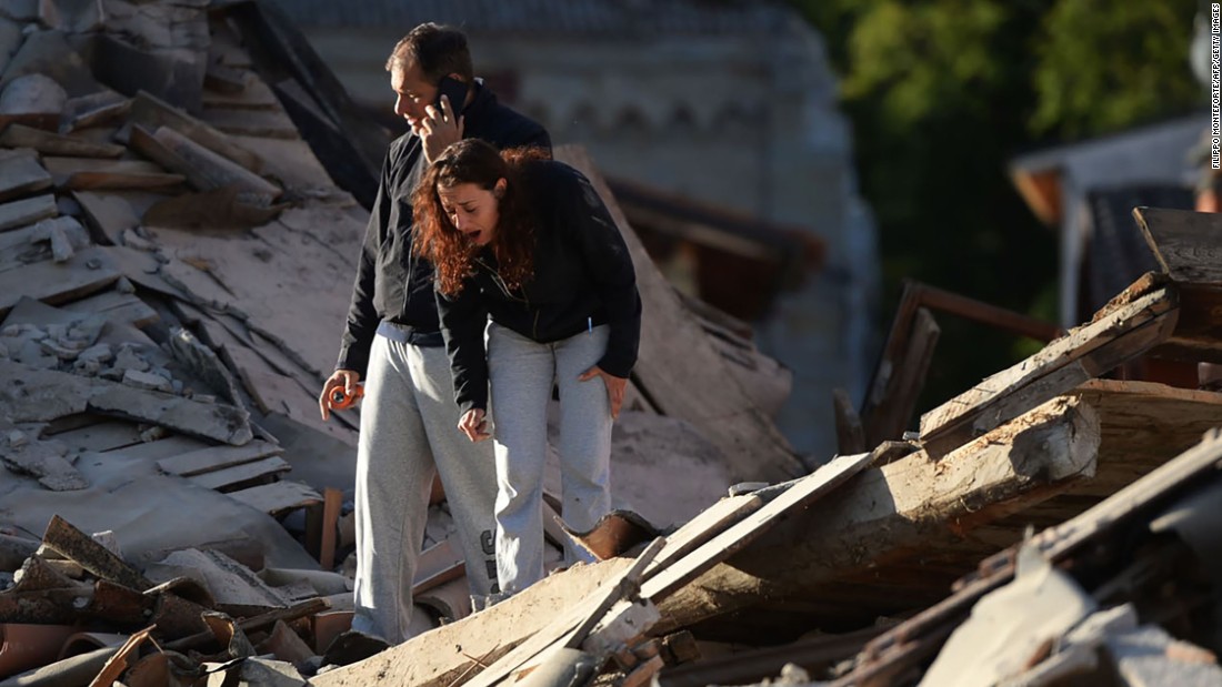 Residents take in the damage in Amatrice.