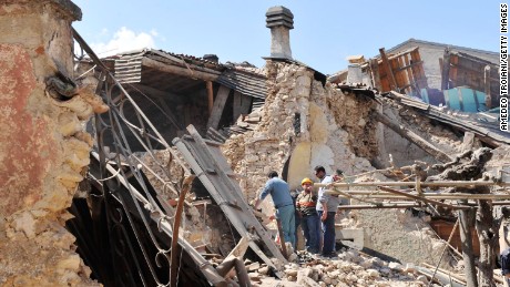 Residents inspect the rubble of buildings destroyed by an earthquake on April 6, 2009 in Onna, Italy. 