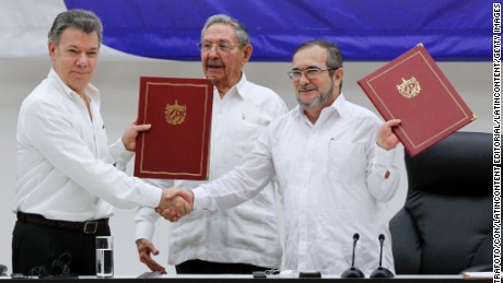 President Juan Manuel Santos, left, and  FARC official Timoleon Jimenez  mark a ceasefire in June. 