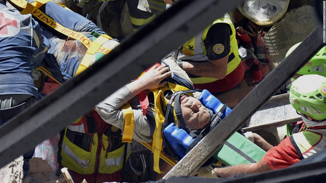 A man is pulled alive from the rubble.