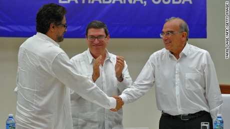 Sealed with a handshake: Colombian government representative Humberto de la Calle, right, and FARC commander Ivan Marquez greet each other after signing a peace deal in Havana.