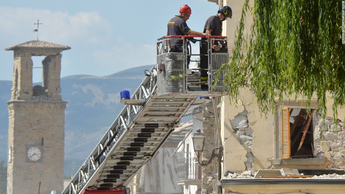 Firefighters inspect a damaged building from the elevated platform of a firetruck in Amatrice on August 26. Amatrice has been the hardest-hit town, with more than 200 killed there.