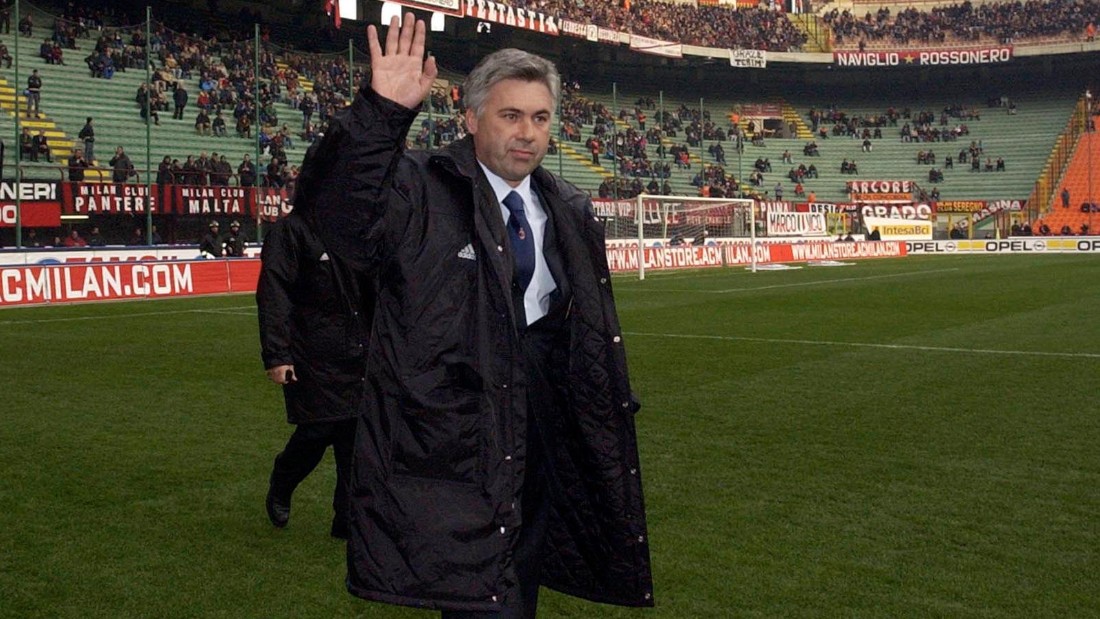 Ancelotti acknowledges the crowd as he walks out for his first match as AC Milan manager in 2001, the first of his 423 games in charge of the club. 