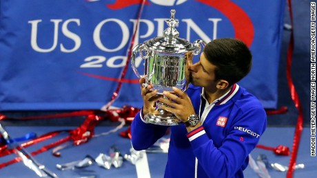 NEW YORK, NY - SEPTEMBER 13:  Novak Djokovic of Serbia celebrates with the winner&#39;s trophy after defeating Roger Federer of Switzerland during their Men&#39;s Singles Final match on Day Fourteen of the 2015 US Open at the USTA Billie Jean King National Tennis Center on September 13, 2015 in the Flushing neighborhood of the Queens borough of New York City. Djokovic defeated Federer 6-4, 5-7, 6-4, 6-4.  (Photo by Maddie Meyer/Getty Images)