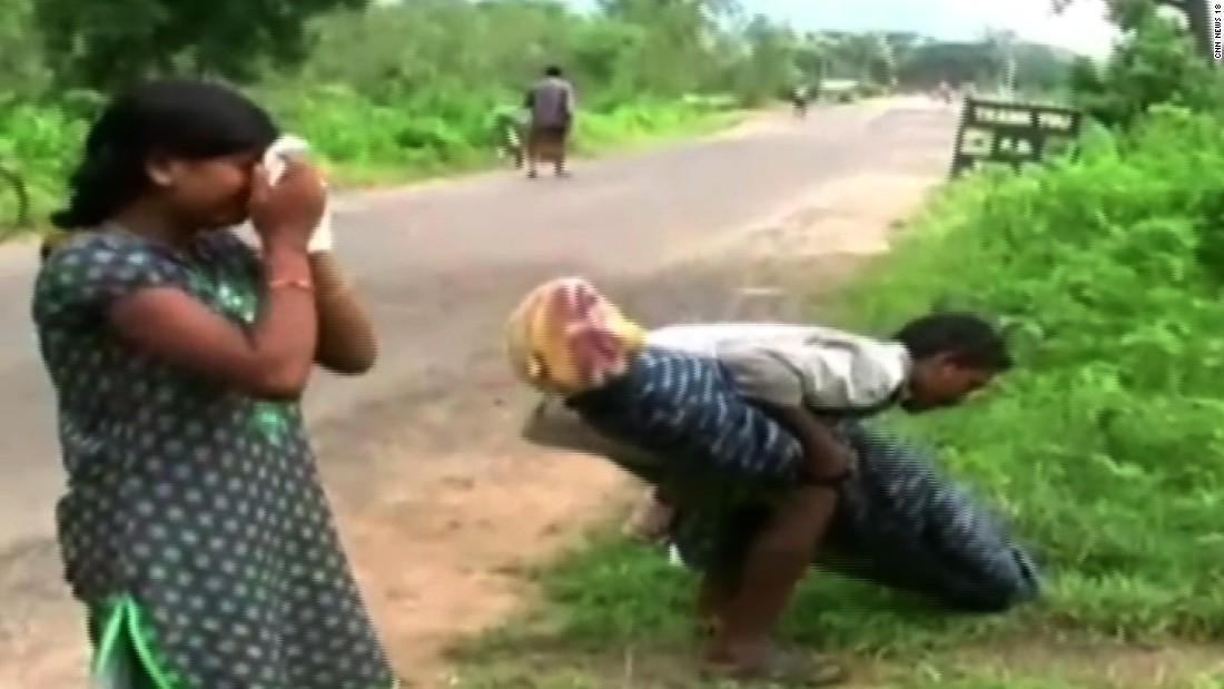 Indian man carries wifes body home from hospi