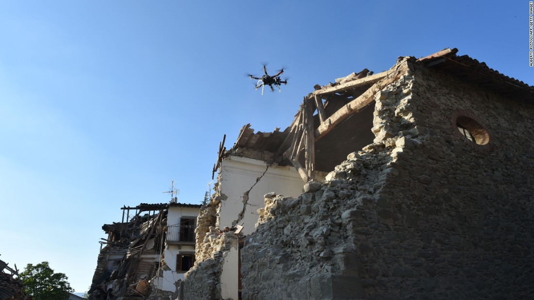 A drone controlled by Italian firefighters flies over damaged houses in San Lorenzo, Italy, on August 27. 
