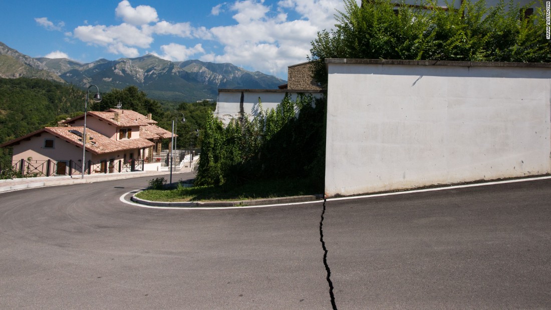 A neat fracture line in the pavement is a telling sign of the earth&#39;s violent movement below the streets of Amatrice.
