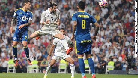 Real Madrid&#39;s Gareth Bale  heads past Pablo Hernandez of Celta Vigo.