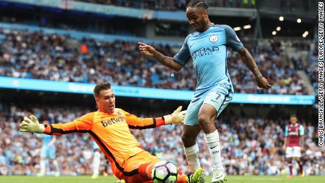 Manchester City&#39;s Raheem Sterling rounds West Ham goalkeeper Adrian to score his second goal.