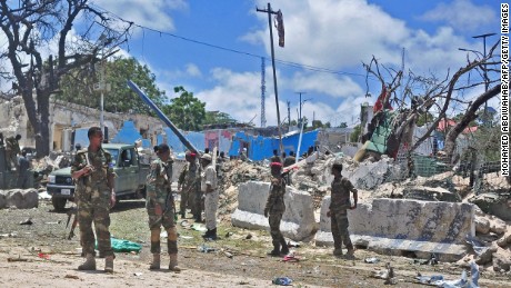 Somali security forces patrol the scene of a suicide car bomb blast Tuesday in Mogadishu.