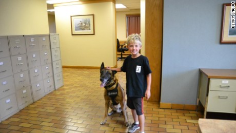 Ethan Engum poses with a police dog at K9 training. 