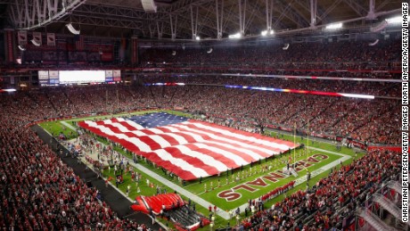 An American flag covers the field during the National Anthem before the NFL game between the Cincinnati Bengals and the Arizona Cardinals  on November 22, 2015.